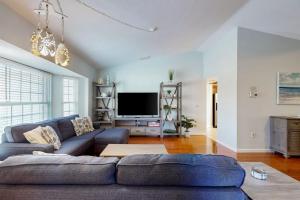 a living room with a blue couch and a tv at Rotonda Getaway in Rotunda-West