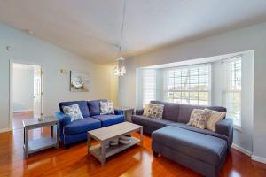 a living room with two blue couches and a table at Rotonda Getaway in Rotunda-West