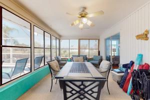 a dining room with a table and chairs and a ceiling fan at Rotonda Getaway in Rotunda-West