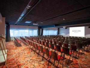an auditorium with chairs in a room with a screen at Mercure Paris Centre Tour Eiffel in Paris