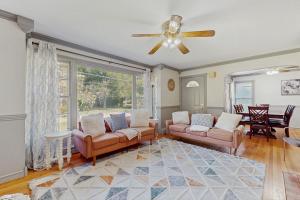 a living room with two couches and a ceiling fan at Charlotte’s Chateau in New Buffalo
