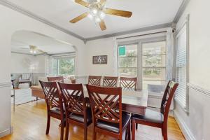 a dining room with a table and chairs and a ceiling fan at Charlotte’s Chateau in New Buffalo
