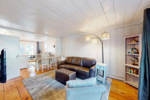 a living room with a couch and a table at Maushop Village Beach Getaway in Mashpee