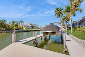 a boat is docked on a dock in the water at Dock Holiday in Marco Island