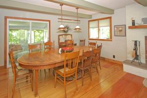 a dining room with a large wooden table and chairs at Hal-Sea-On House in Glen Arbor