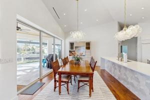 a dining room with a wooden table and chairs at Dock Holiday in Marco Island