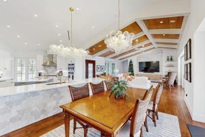 a kitchen and dining room with a wooden table and chairs at Dock Holiday in Marco Island