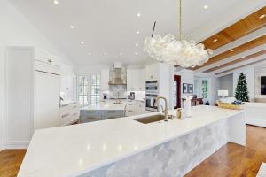 a white kitchen with a large white counter top at Dock Holiday in Marco Island +19 photos