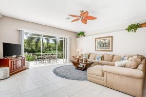 a living room with a couch and a tv at Cape Coral Haven in Cape Coral