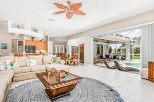 a living room with a couch and a table at Cape Coral Haven in Cape Coral