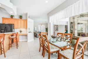 a kitchen and dining room with a glass table and chairs at Cape Coral Haven in Cape Coral