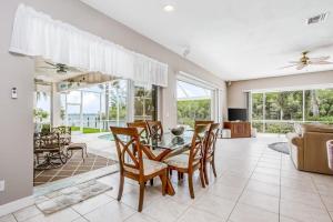 an open living room with a table and chairs at Cape Coral Haven in Cape Coral +33 photos