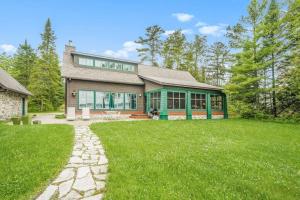 a large house with a grass yard in front of it at Platte Lake Paradise in Beulah