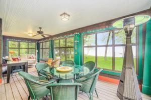 a dining room with a glass table and chairs at Platte Lake Paradise in Beulah