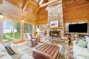 a living room with a fireplace and a tv at Platte Lake Paradise in Beulah