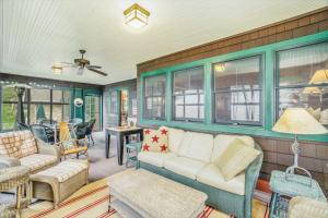a living room with a white couch and chairs at Platte Lake Paradise in Beulah +26 photos