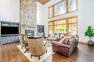 a living room with a couch and a fireplace at Buckaroo in Thompsonville