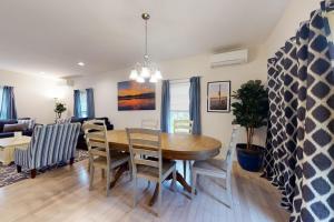 a dining room and living room with a table and chairs at Oak Bluffs Beauty in Oak Bluffs