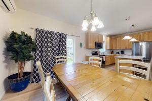 a kitchen with a wooden table and a dining room at Oak Bluffs Beauty in Oak Bluffs