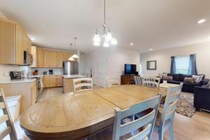 a kitchen and living room with a wooden table and chairs at Oak Bluffs Beauty in Oak Bluffs +23 photos