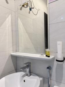 a bathroom with a sink and a shower and a toilet at بستان الورد 2 in Taif +2 photos