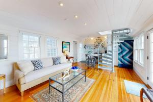 a living room with a couch and a staircase at The Lighthouse in Provincetown