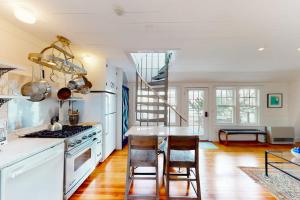 a kitchen with a table and chairs and a staircase at The Lighthouse in Provincetown +18 photos