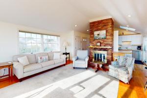 a living room with a couch and a fireplace at West Dennis Dockside in West Dennis