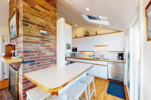 a kitchen with a brick wall and a white counter top at West Dennis Dockside in West Dennis