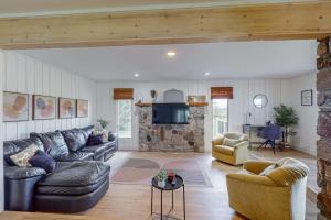 a living room with a couch and a stone fireplace at Minutes from it All in Petoskey