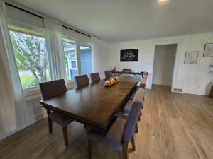 a dining room with a wooden table and chairs at Minutes from it All in Petoskey