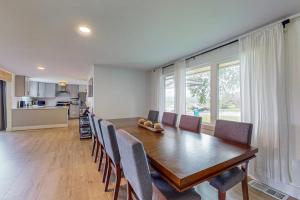 a dining room with a wooden table and chairs at Minutes from it All in Petoskey +19 photos
