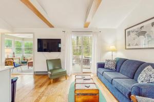 a living room with a blue couch and a table at Lake Michigan Adventures in Lakeside