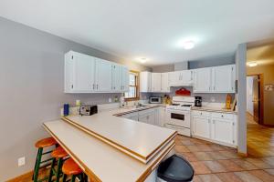 a kitchen with white cabinets and a counter top at Crystal Haven in Thompsonville