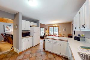 a kitchen with white cabinets and a counter top at Crystal Haven in Thompsonville