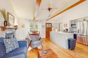 a living room with a blue couch and a kitchen at Lake Michigan Adventures in Lakeside