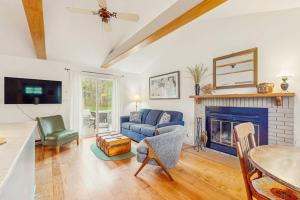 a living room with a blue couch and a fireplace at Lake Michigan Adventures in Lakeside