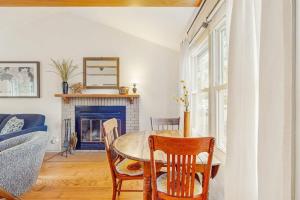 a dining room with a table and chairs and a fireplace at Lake Michigan Adventures in Lakeside +23 photos