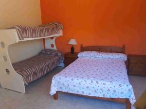 a bedroom with a bed and a bunk bed at Casa Miramar Costa Atlantica Rep Argentina in Miramar