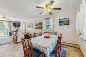 a dining room with a table and a ceiling fan at Old Orchard in Edgartown +14 photos
