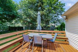 a table and chairs with an umbrella on a deck at Old Orchard in Edgartown