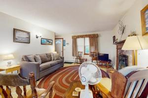 a living room with a couch and a fan at Escape in Dennis in Dennis