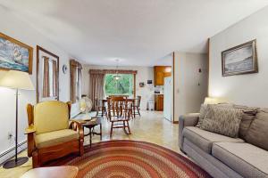 a living room with a couch and a dining room at Escape in Dennis in Dennis