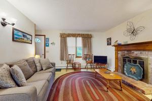 a living room with a couch and a fireplace at Escape in Dennis in Dennis +21 photos