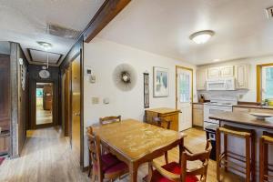 a kitchen and dining room with a wooden table at The Rootskeller in Oak Bluffs