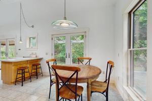 a kitchen with a table and chairs in a room at The Lemonade Stand in West Tisbury