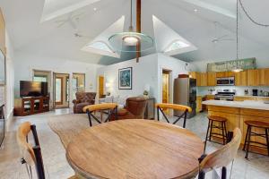 a kitchen and living room with a wooden table and chairs at The Lemonade Stand in West Tisbury