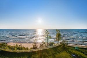 a view of the ocean from a beach with a fence at Lake Michigan Retreat- Upper Duplex in Benton Harbor