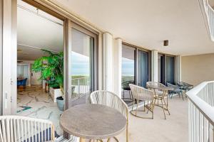 a room with a table and chairs and windows at Waves & Palms Oasis in Marco Island