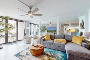 a living room with a couch and a table at Waves & Palms Oasis in Marco Island
